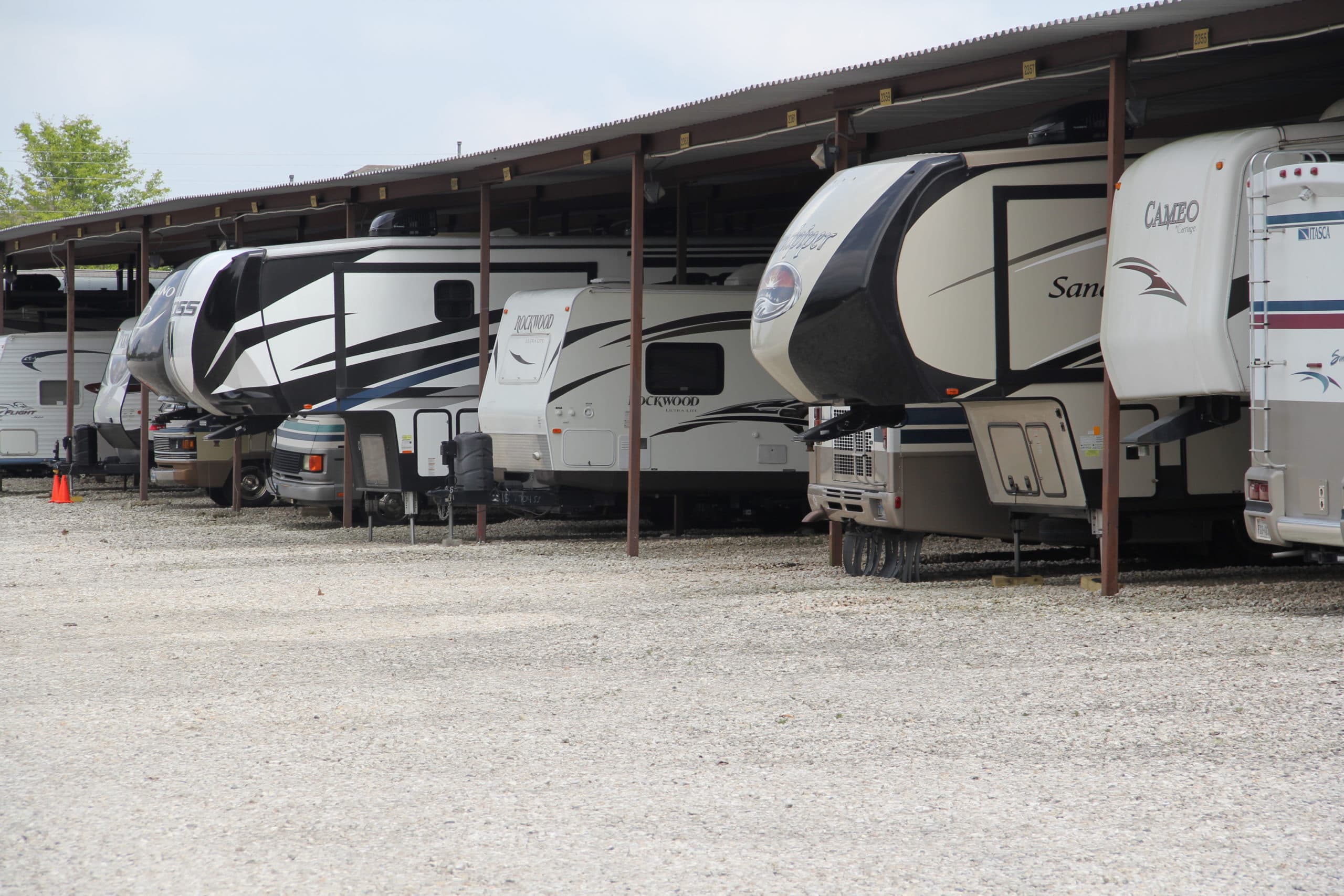 RVs parked beneath covered storage in Round Rock